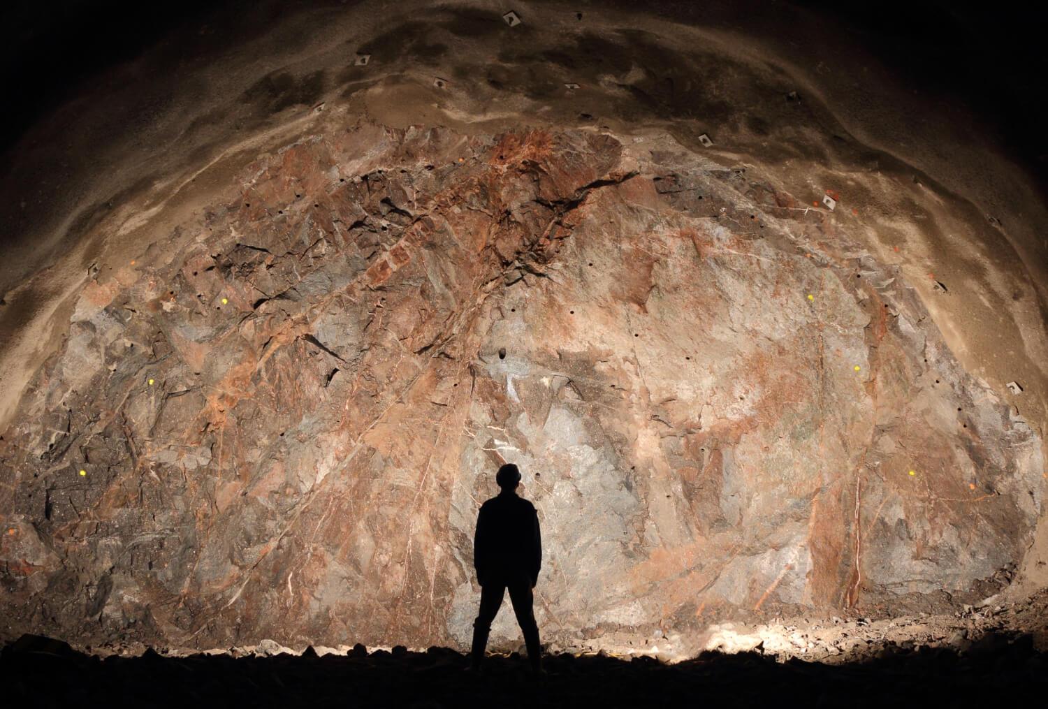 Person in Underground Mine looking at wal