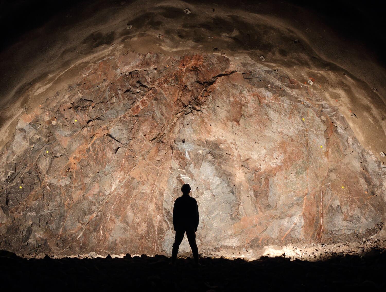 Underground miner standing in front of a wall